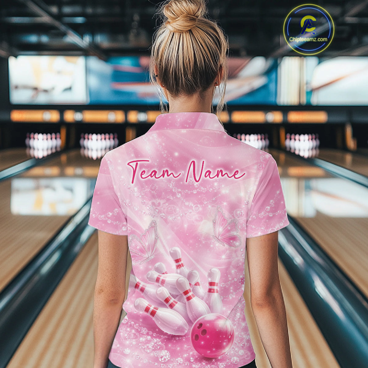 Back view female model wearing polo shirt with flaming bowling ball crashing into pins blue fiery bowling artwork