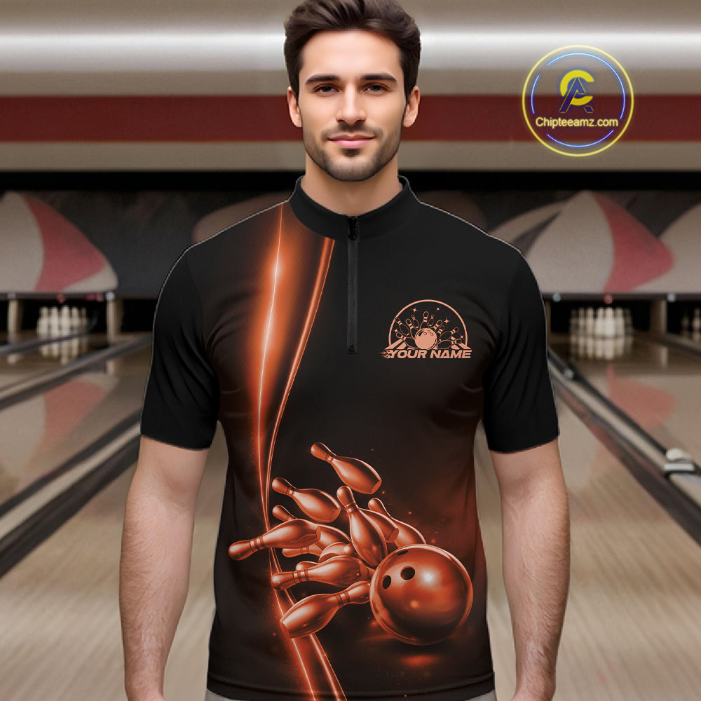 Front view of a male model in a bowling lane wearing a black quarter-zip shirt with orange bowling ball and pins artwork and dynamic bowling action visuals.