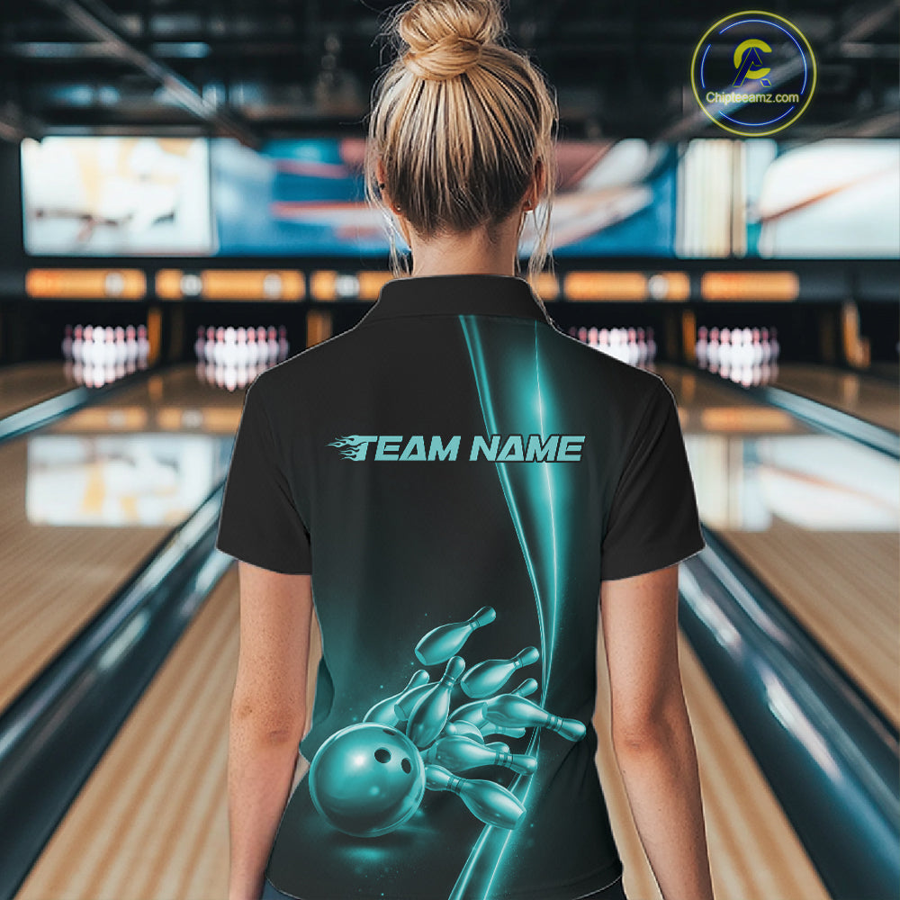 Back view of a female model in a bowling lane wearing a black quarter-zip shirt featuring turquoise blue bowling ball and pins design with sporty bowling graphics.