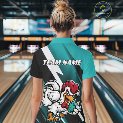 A woman viewed from behind wearing a custom-designed bowling team polo shirt with a teal and black color-blocked design, a white lightning bolt, and a cartoon rooster mascot holding a bowling ball. The background shows a blurred bowling alley with lanes and pins.