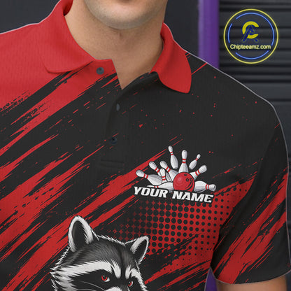 A close-up of a person wearing a short-sleeve polo shirt with a black and red graphic design, a raccoon illustration, and a bowling pin/ball graphic above the text 'YOUR NAME'. 