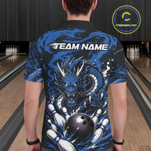 Load image into Gallery viewer, Person wearing a blue dragon-themed bowling shirt with 'TEAM NAME' text in a bowling alley.