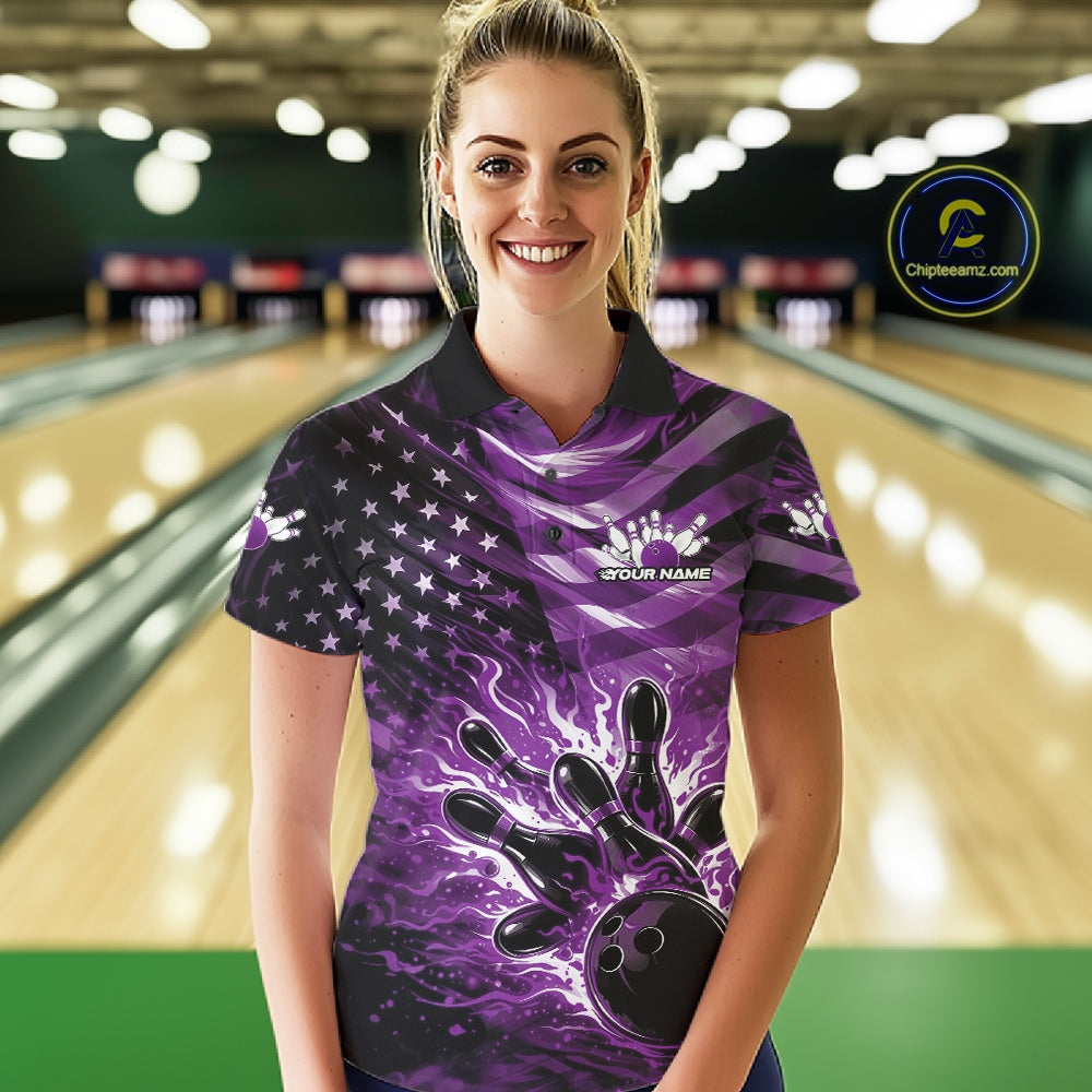 Female model wearing a black bowling polo shirt at the bowling lane with purple flame bowling graphics and patriotic-themed artwork.
