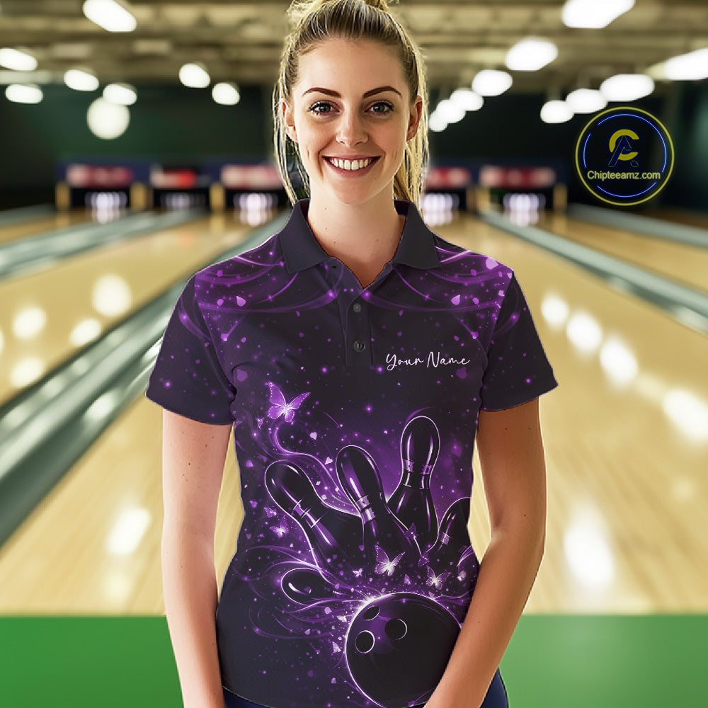 Female model wearing a black and purple bowling polo shirt at the lane with glowing butterfly bowling artwork.