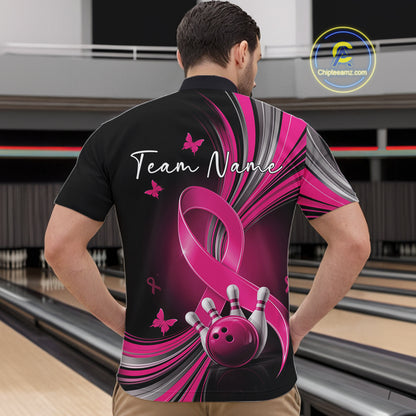 Male model wearing a black and pink bowling quarter zip with pink ribbon artwork, small butterflies, and bowling graphics at the bowling lane