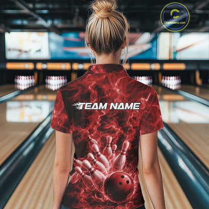 Back view of a womens bowling polo showcasing a red bowling ball knocking down pins with dramatic flames.