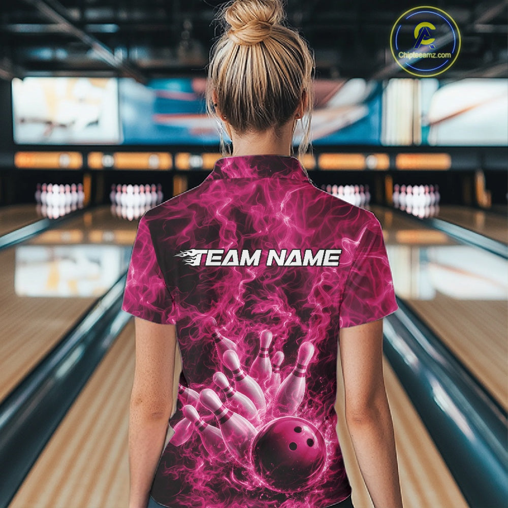 Back view of a womens bowling polo displaying a pink bowling ball hitting pins with dramatic flame accents.
