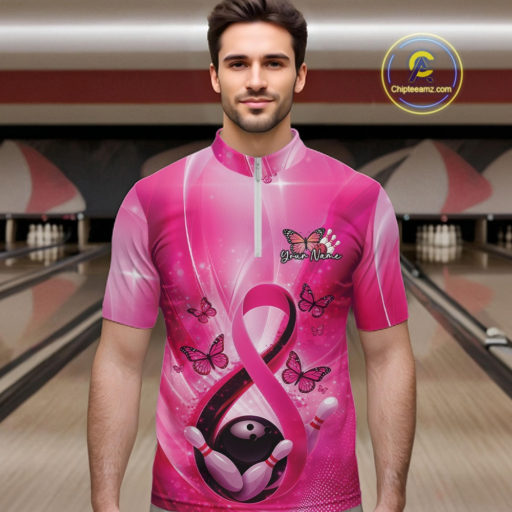 Male model wearing a bowling quarter-zip at the bowling lane displaying pink ribbon, butterfly, and bowling-themed graphics.