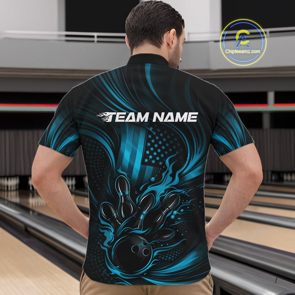 Front view of a male model in a bowling venue wearing a black and turquoise blue quarter-zip shirt showcasing a flaming bowling ball and patriotic pin design.