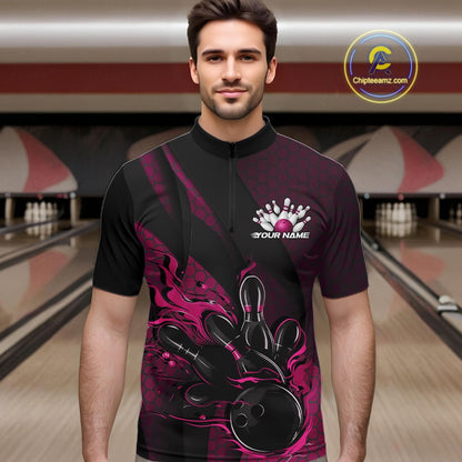 Male model at a bowling lane wearing a black and pink bowling quarter-zip shirt with bowling strike artwork, geometric accents, and diagonal striping.