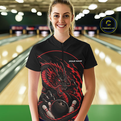Front view of a happy female model in a bowling alley wearing a red custom quarter-zip bowling shirt featuring an aggressive dragon with flames in a dynamic and energetic design.