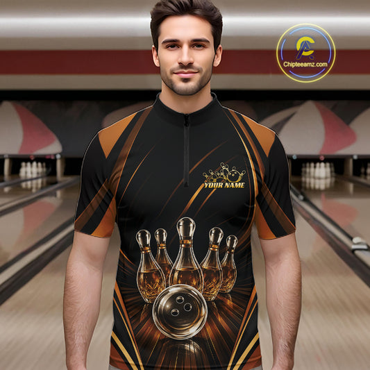 A man wearing a black and brown bowling-themed short-sleeve quarter-zip shirt with bowling pins bowling pin cluster and ball graphic, standing in a bowling alley.