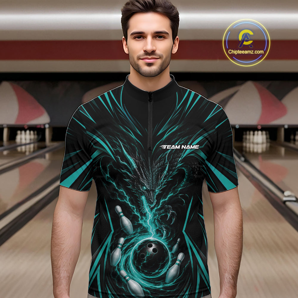 A man wearing a black short-sleeve bowling jersey with a teal and black dragon and bowling graphics, standing in front of a bowling alley background.