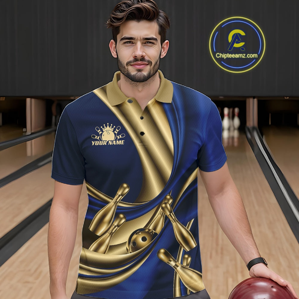 A man wearing a custom bowling-themed polo shirt in a bowling alley. The shirt features a blue and gold satin-sheer design with bowling pins and a bowling ball graphic, and a gold logo on the left chest.