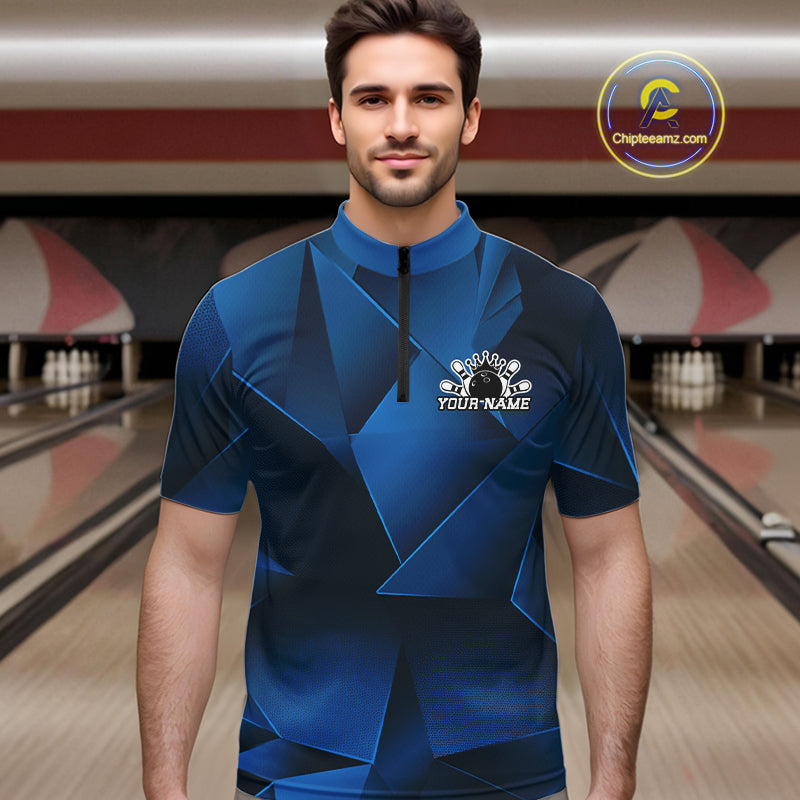 Man wearing a blue bowling shirt with a logo in a bowling alley