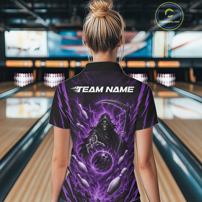A woman viewed from behind wearing a black short-sleeve polo bowling shirt with a large purple grim reaper graphic and the text 'TEAM NAME' on the back, standing in a bowling alley.