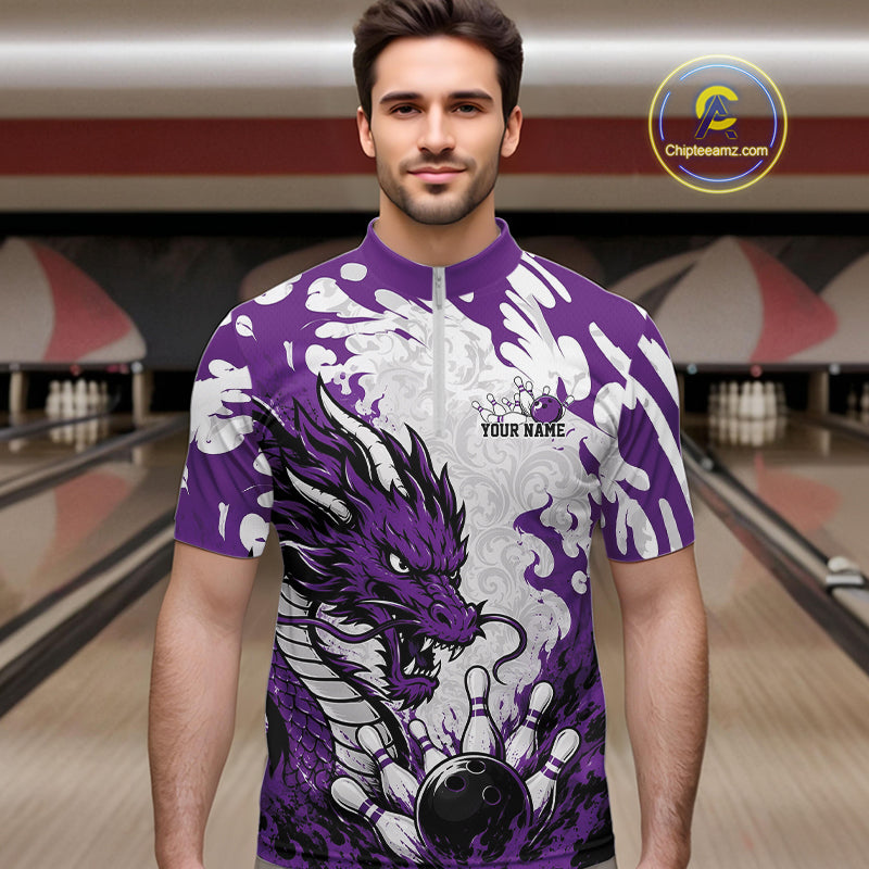 Man wearing a purple and white bowling shirt with a dragon design in a bowling alley.