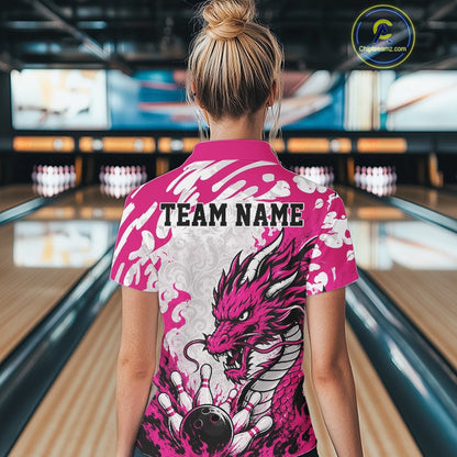 Person wearing a pink bowling shirt with dragon design and 'TEAM NAME' text in a bowling alley.