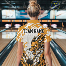 Load image into Gallery viewer, Person wearing a yellow bowling shirt with a dragon design and 'TEAM NAME' text in a bowling alley.
