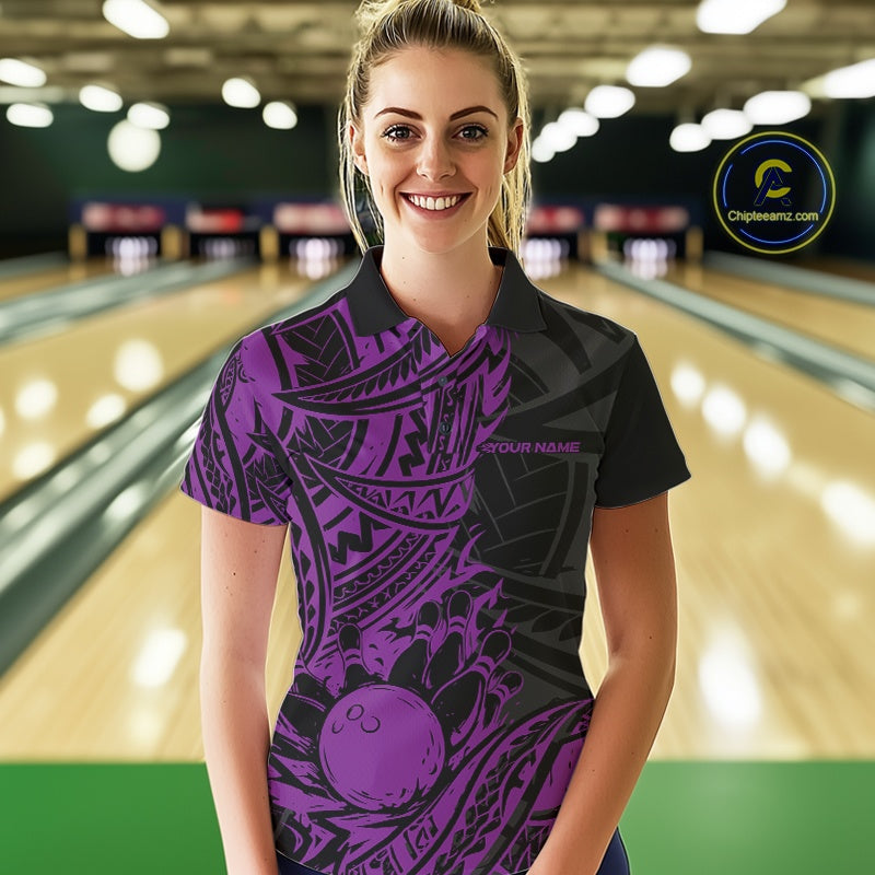 Woman wearing a black and purple bowling shirt in a bowling alley.