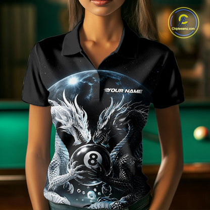 A woman wearing a black short-sleeve polo shirt with a detailed graphic print of two dragons around an 8-ball, with a green pool table blurred in the background.