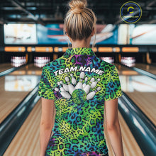 Load image into Gallery viewer, Back view of a woman standing at a bowling alley, wearing a gold, brown, and black leopard-print bowling polo with “Team Name” and bowling pins on the back.