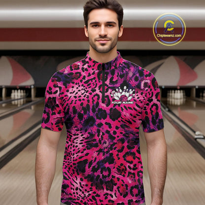 Man in a bowling alley wearing a pink, purple, and black leopard-print bowling quarter zip shirt with “Your Name” and a bowling pins graphic on the chest.
