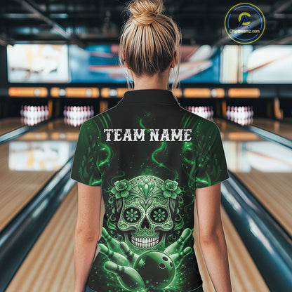 Back view of a female model in a bowling center wearing a black and green quarter-zip shirt featuring a Day of the Dead bowling motif.