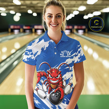 Load image into Gallery viewer, Front view of a female model in a bowling alley wearing a blue custom bowling polo shirt with a fierce yet funny crawfish bowling character and a distressed background design.