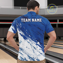 Load image into Gallery viewer, Front view of a male bowler in a bowling alley wearing a white and blue bowling quarter-zip shirt with a dynamic splatter sports jersey design