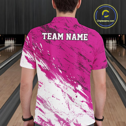 Person wearing a pink and white bowling shirt with 'TEAM NAME' on the back, standing in a bowling alley.