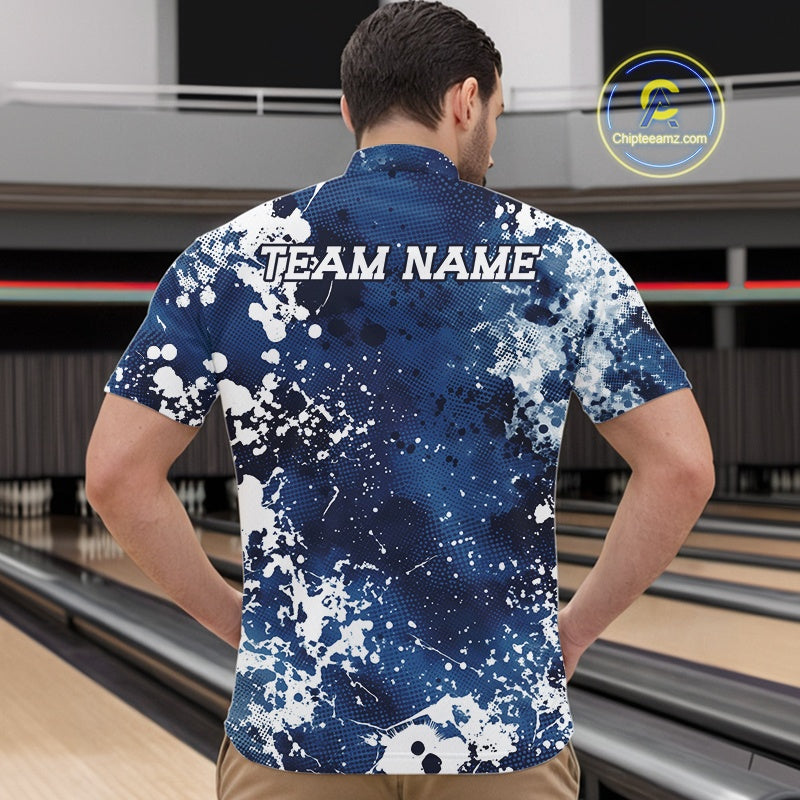 Man wearing a blue and white patterned bowling shirt with 'TEAM NAME' on the back, standing in a bowling alley.