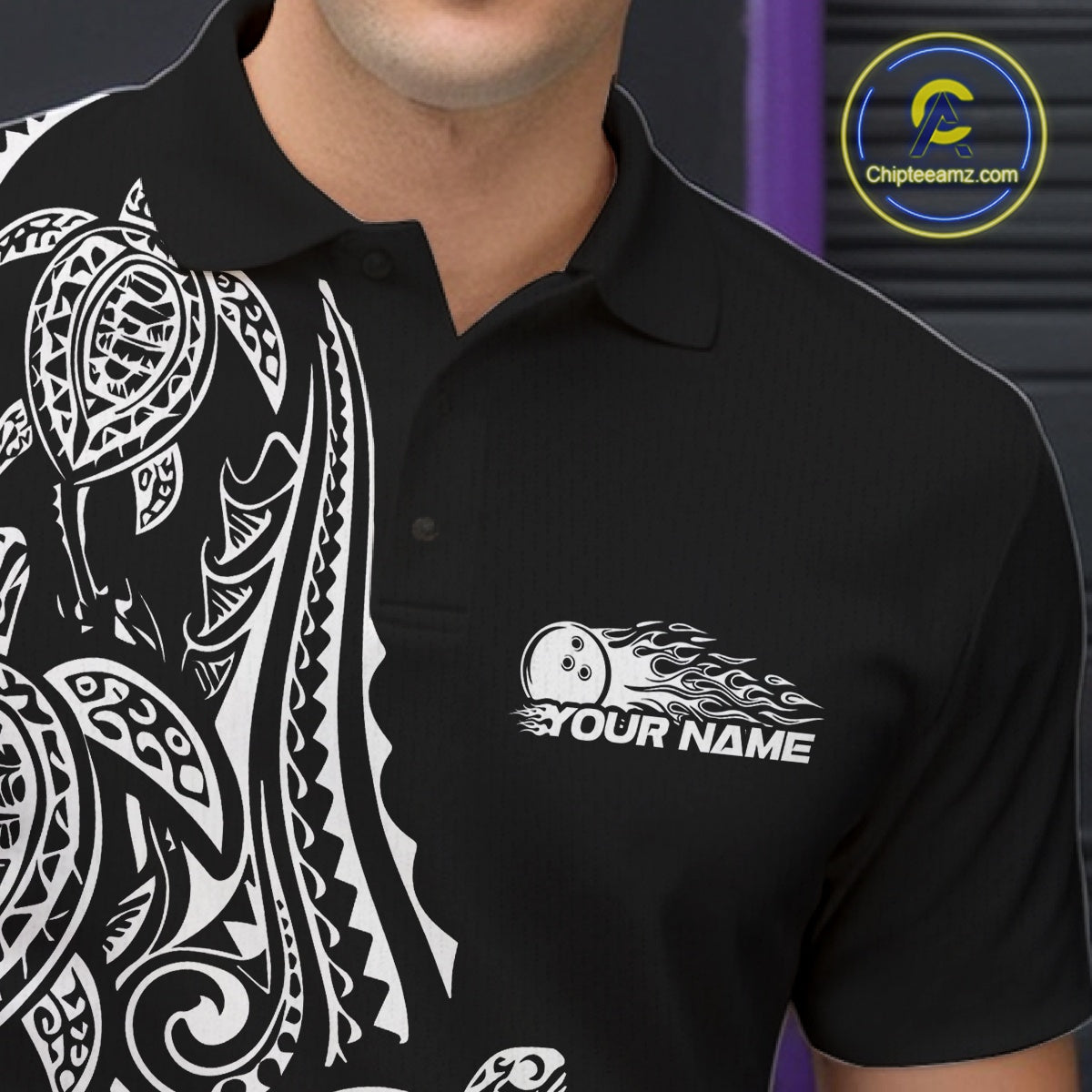 Left chest close-up of a black and white bowling polo shirt displaying Polynesian-style bowling graphics and tribal details.