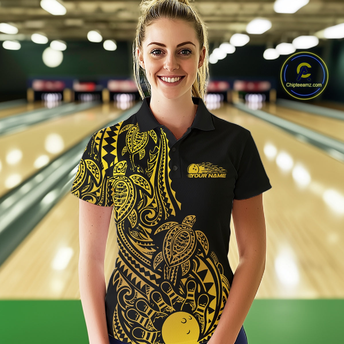 Female model wearing a black and gold bowling polo shirt at the lane with Polynesian-inspired bowling motifs.