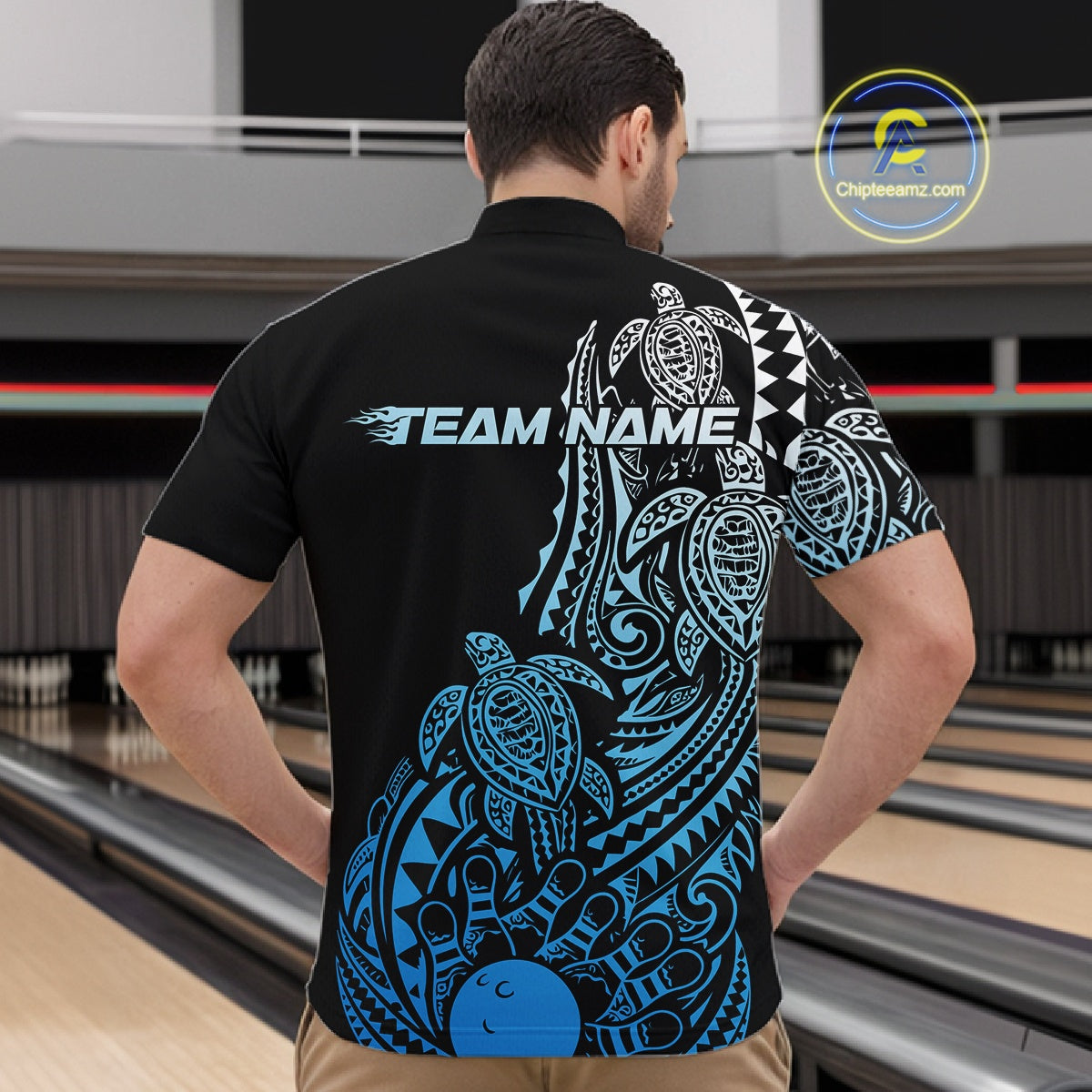 Front view of a male model in a black and blue bowling quarter-zip shirt displaying tribal bowling graphics and turtle patterns.