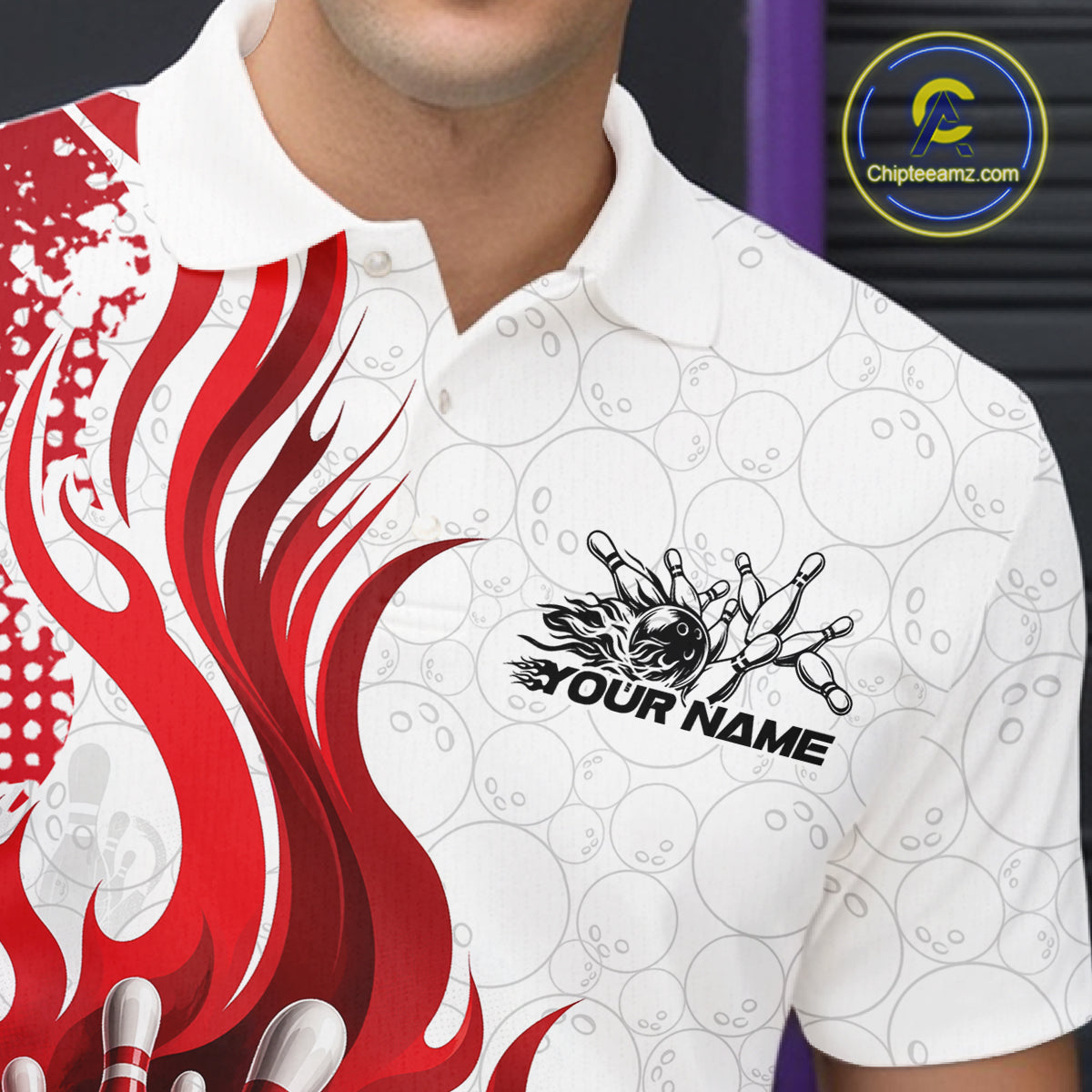 A close-up of a white short-sleeve polo shirt worn by a model, featuring a bold red flame graphic on the left side and a black bowling pin graphic with the text 'YOUR NAME' on the chest. 