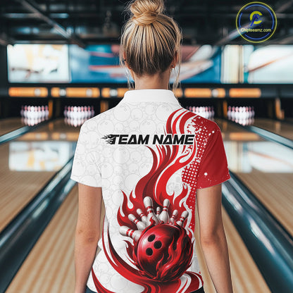 A woman viewed from behind wearing a white and red bowling-themed short-sleeve collared shirt with a flame and bowling ball graphic, standing in a bowling alley.