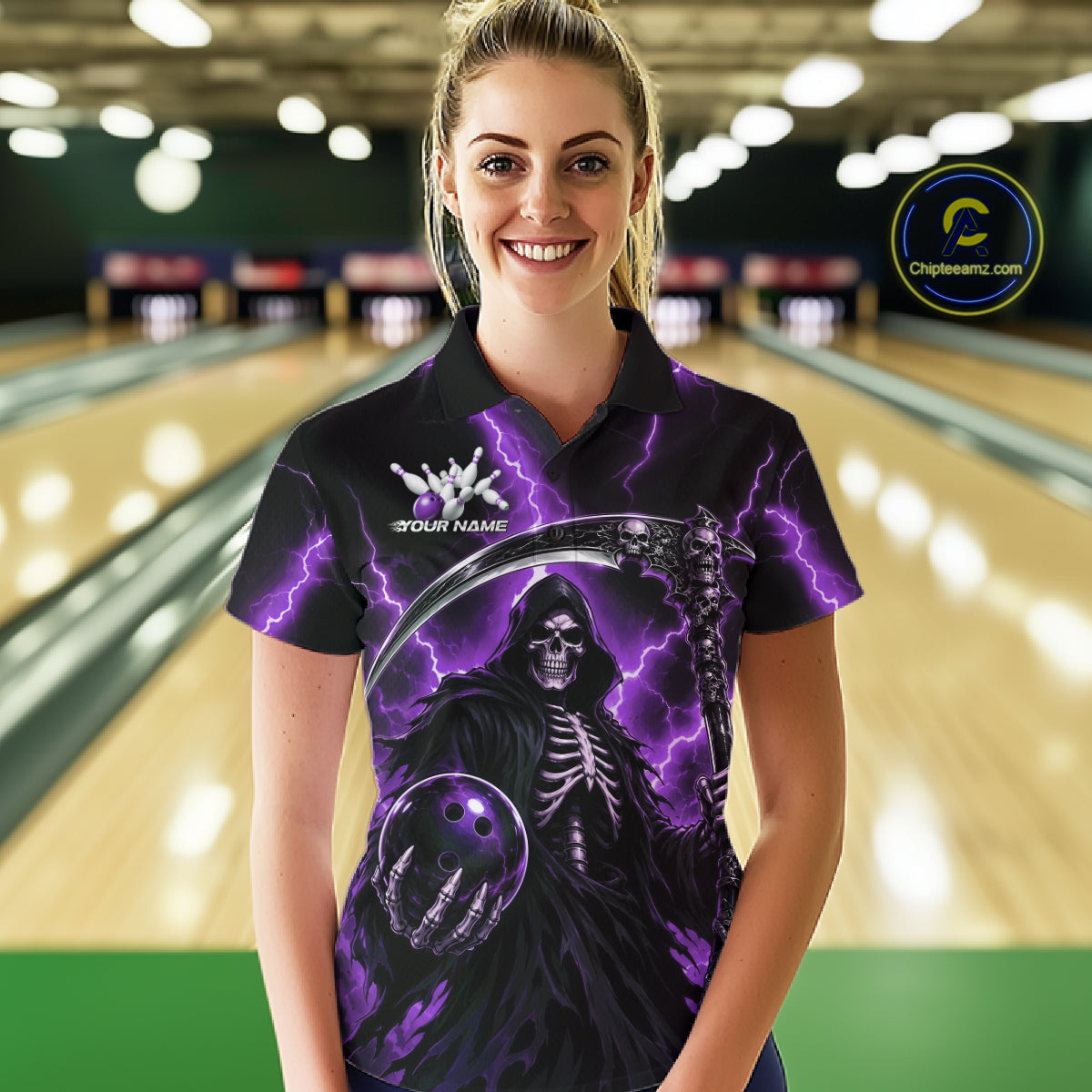 A woman wearing a custom black short-sleeve polo shirt with a purple and black grim reaper graphic, standing in a bowling alley. The shirt features a skeleton holding a bowling ball with purple lightning effects