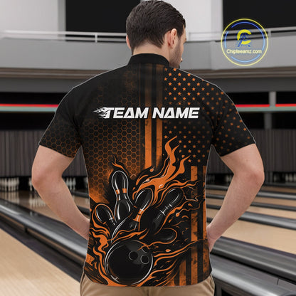 Front view of a male model in a bowling alley wearing a black and orange quarter-zip shirt showcasing a flaming bowling ball and bowling pins.