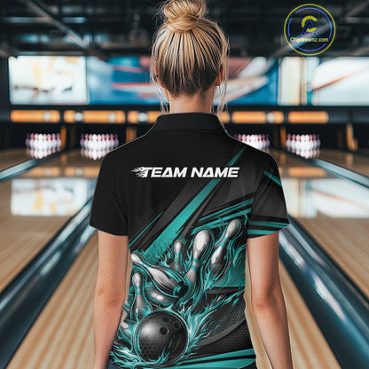 Back view of a female bowler wearing a black quarter-zip shirt, turquoise flame bowling ball and pins artwork combined with abstract stripe graphics.