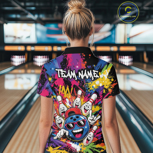A woman viewed from behind wearing a colorful bowling-themed short-sleeve shirt with a black collar, standing in a bowling alley. The shirt features a vibrant multicolor graphic with bowling pins, a bowling ball, and the text 'TEAM NAME'.