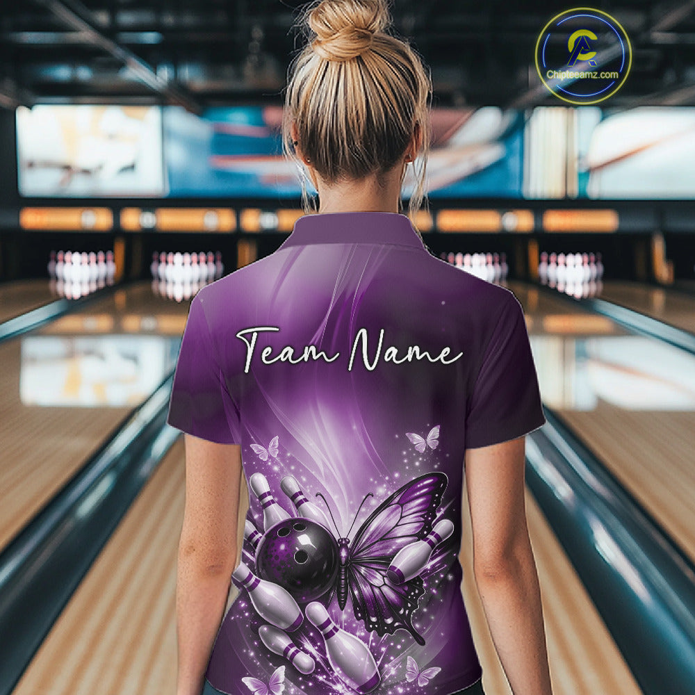 Back view of a female model in a bowling alley wearing a purple bowling quarter-zip shirt featuring a butterfly beside a bowling ball and pins.
