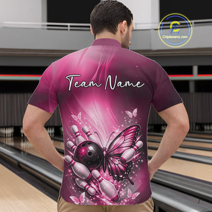 Front view of a male model in a bowling center wearing a pink quarter-zip bowling shirt featuring butterfly and bowling-themed graphics.
