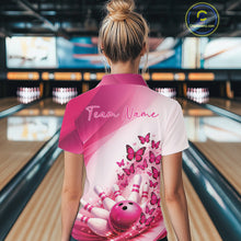 Load image into Gallery viewer, Back view of a female model wearing a white and pink bowling polo with butterfly graphics and bowling artwork at the bowling lane