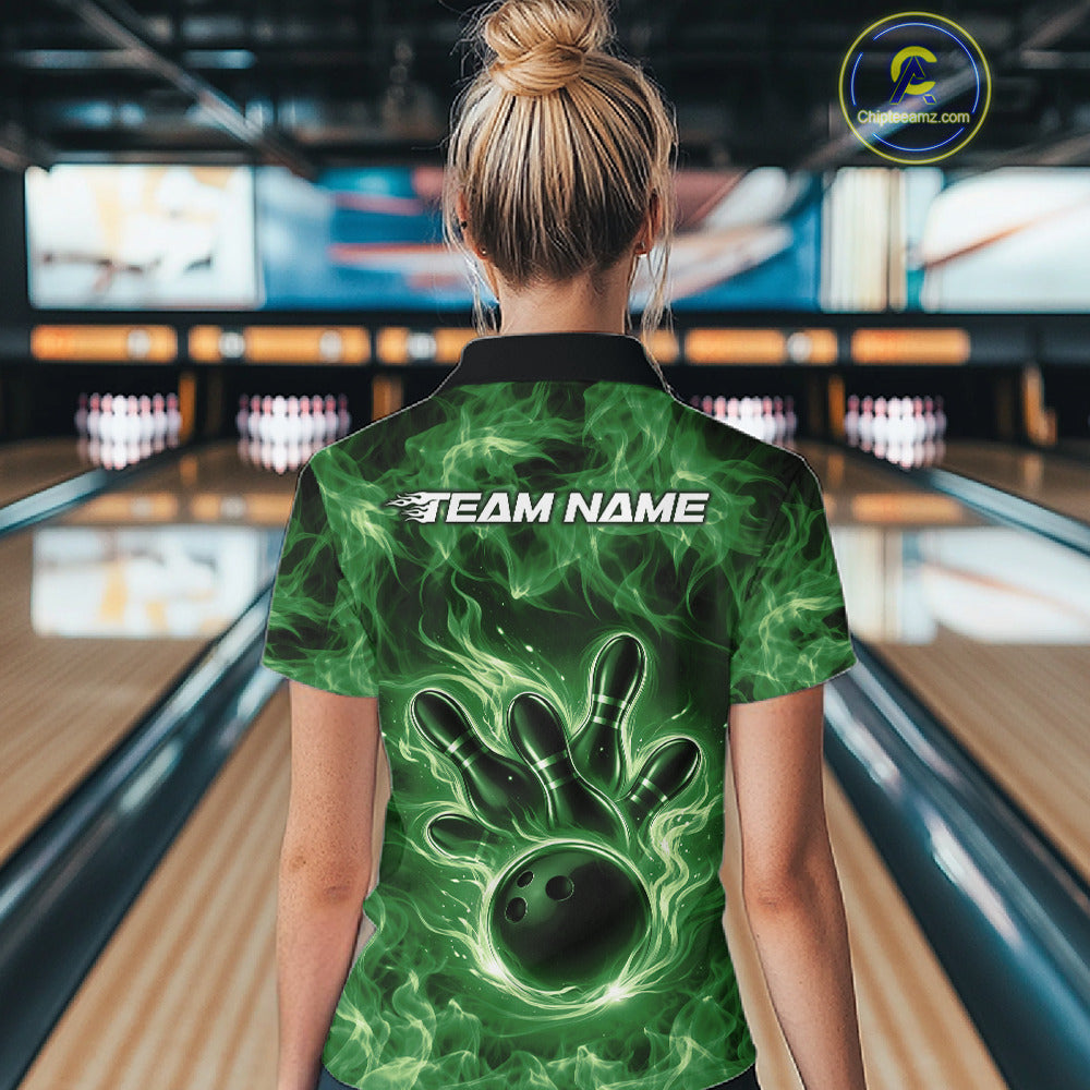 Back view of a green womens bowling polo showcasing a bowling ball surrounded by flames.