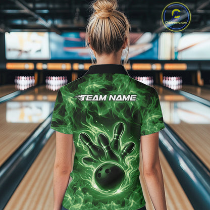 Back view of a green womens bowling polo showcasing a bowling ball surrounded by flames.