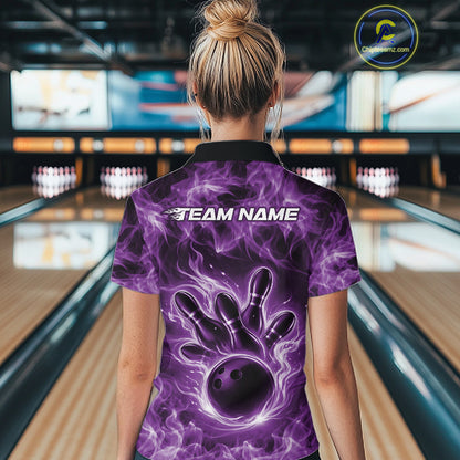 Back view of a purple womens bowling polo showcasing a bowling ball surrounded by blazing flames.