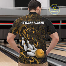 Load image into Gallery viewer, Male model wearing a black and yellow bowling quarter-zip shirt in a bowling alley featuring a tribal flame bowling ball and pins graphic