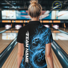 Load image into Gallery viewer, Back view of a female bowler wearing a black bowling quarter-zip shirt featuring a blue flaming skull holding a bowling ball with swirling energy effects