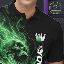 Load image into Gallery viewer, Close-up of the left chest on a black bowling polo shirt featuring a skull clutching a bowling ball with swirling green energy flames